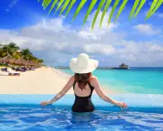 10489414-black-swimsuit-woman-rear-view-in-a-pool-with-direct-view-to-tropical-Caribbean-sea-Stock-Photo