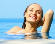 stock-footage-beaufitul-woman-resting-in-infinity-swimming-pool