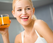 Young attractive happy woman with glass of juice