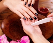 Manicurist master  makes manicure on woman's hands - Spa treatme