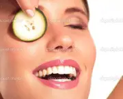 Young beautiflul smiling girl applying a cucumber beauty treatment
